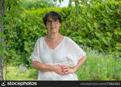 a portrait of a beautiful senior woman in the garden