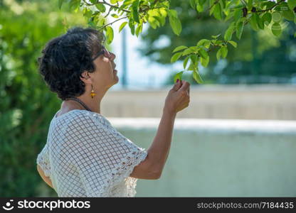 a portrait of a beautiful senior woman in the garden