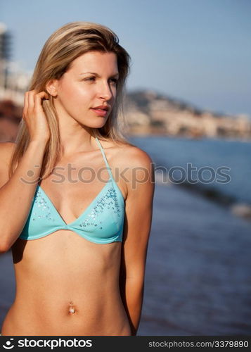 A portrait of a beautiful woman walking on the beach