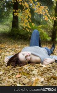 A portrait of a beautiful young girl lying on the ground