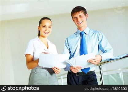 A portrait of a businesswoman and a businessman working together as a team im the office