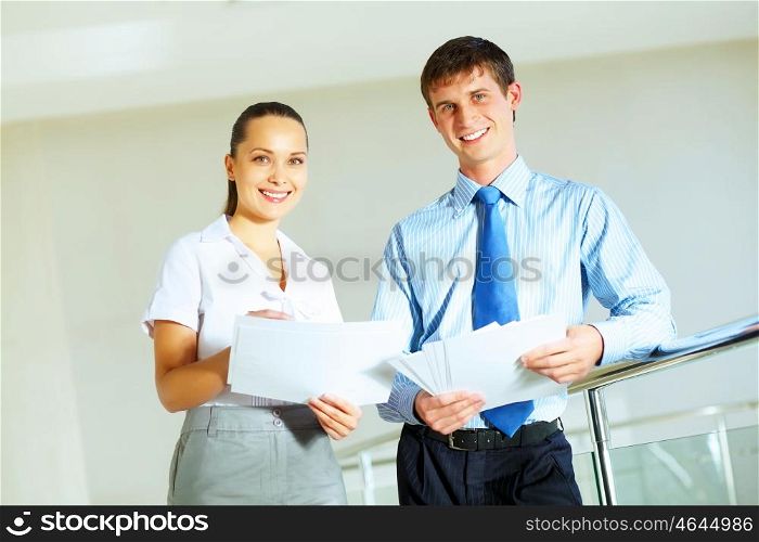a portrait of a businesswoman and businessman. A portrait of a businesswoman and a businessman working together as a team im the office