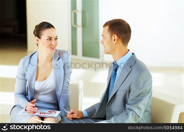 a portrait of a businesswoman and businessman. A portrait of a businesswoman and a businessman working together as a team im the office