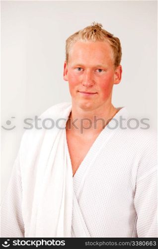 A portrait of a content man wearing a bathrobe