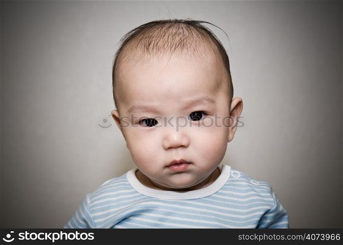 A portrait of a cute asian baby staring