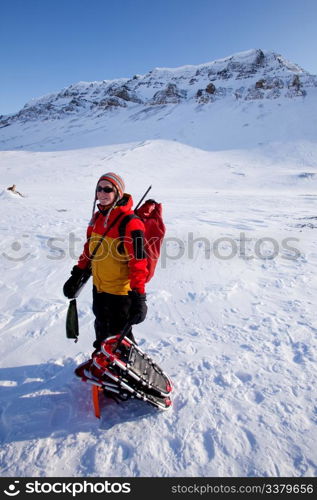 A portrait of a female adventurer against a mountain landscape