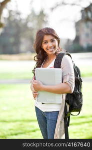 A portrait of a happy asian student on campus