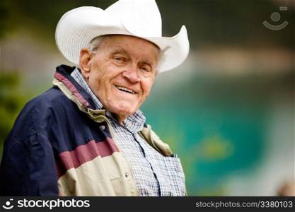 A portrait of a happy elderly man with cowboy hat