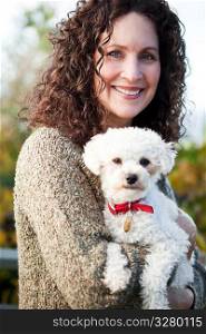 A portrait of a happy mature woman with her dog outdoor