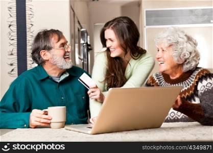 A portrait of a happy senior couple shopping online with the help from their granddaughter
