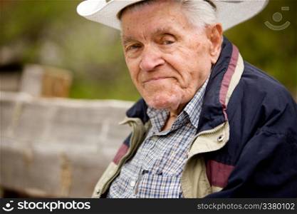 A portrait of a happy senior man on a bench