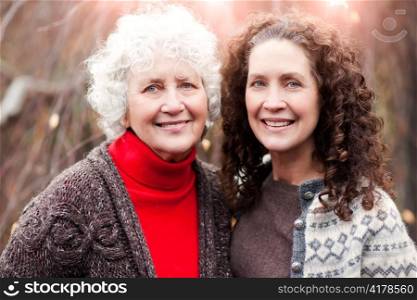 A portrait of a happy senior woman with her adult daughter