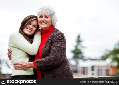 A portrait of a happy teen granddaughter with her grandmother