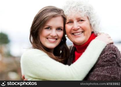 A portrait of a happy teen granddaughter with her grandmother