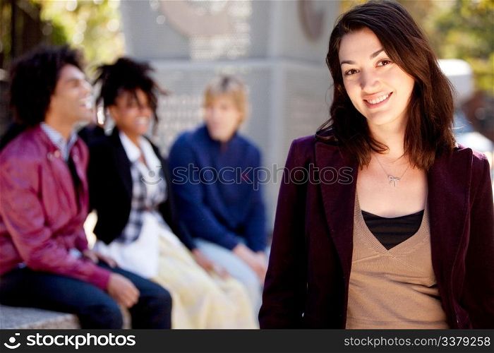 A portrait of a happy young woman with friends