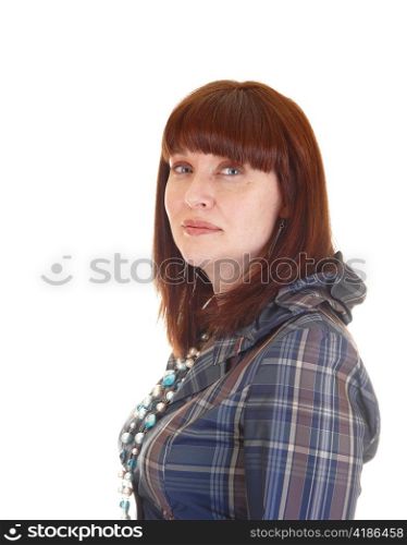 A portrait of a lovely forty years old woman with red hair and a bluecheckered blouse in profile for white background.