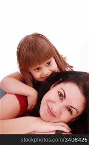 A portrait of a mother and her baby girl lying on the floor and smiling over white background
