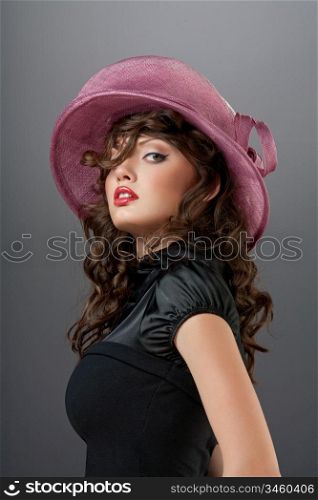 A portrait of a passionate independent lady wearing a pretty retro hat.