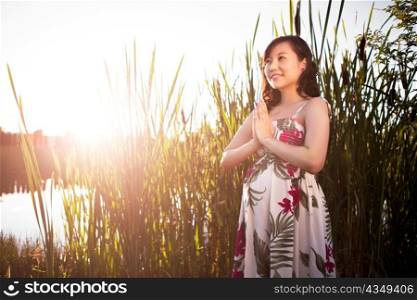 A portrait of a pregnant asian woman outdoor