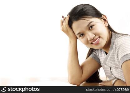 A portrait of a pretty woman smiling at her desk