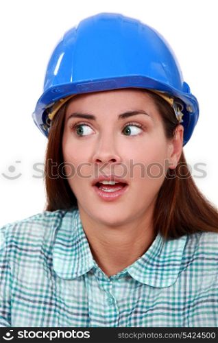 A portrait of a scared female construction worker.