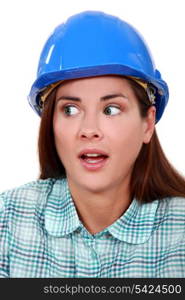 A portrait of a scared female construction worker.