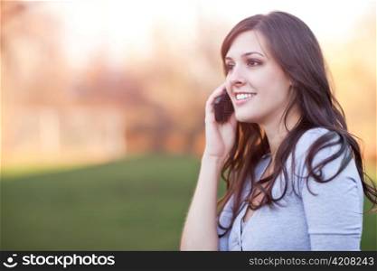 A portrait of a smiling beautiful woman talking on the phone