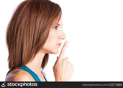 A portrait of a woman shushing with her finger on her lips