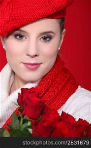 A portrait of a woman with red roses.