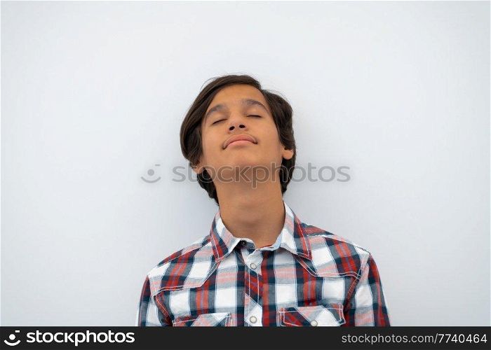 a portrait of a young attractive Arab boy isolated on a white background. High quality photo. a portrait of a young attractive Arab boy isolated on a white background