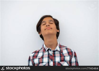 a portrait of a young attractive Arab boy isolated on a white background. High quality photo. a portrait of a young attractive Arab boy isolated on a white background