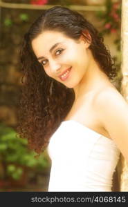 A portrait of a young attractive woman with curly hair.