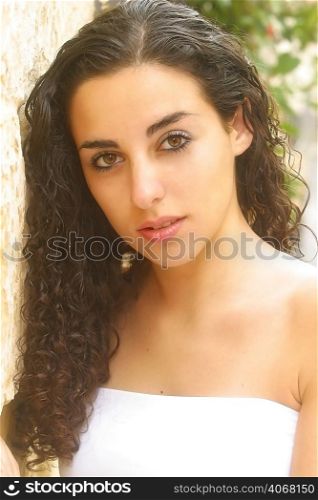 A portrait of a young attractive woman with curly hair.