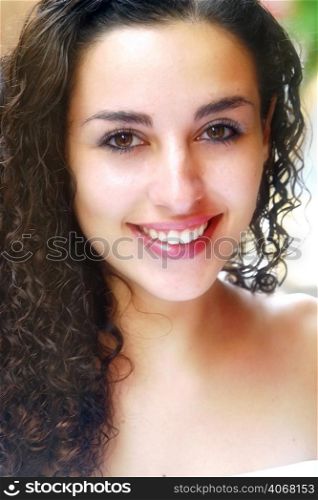 A portrait of a young attractive woman with curly hair.