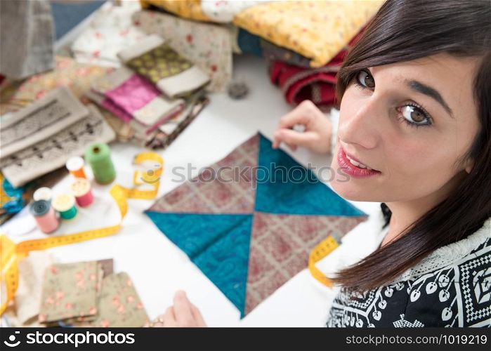 a portrait of a young seamstress in her studio