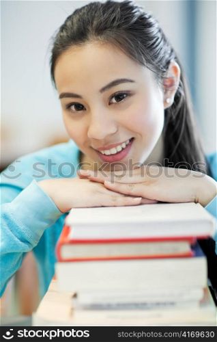 A portrait of an Asian college student studying in the library