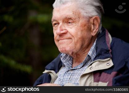 A portrait of an elderly man in the forest