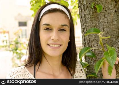 a portrait of beautiful happy young woman outdoors