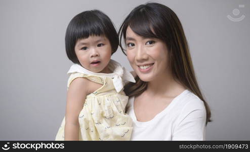 A portrait of happy asian mom and daughter . Portrait of happy asian mom and daughter