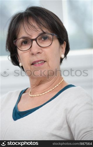 a portrait of middle age brunette with glasses