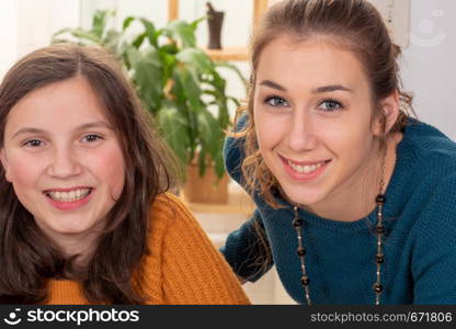 a portrait of pretty beautiful charming adorable with long hair girl and her older friend