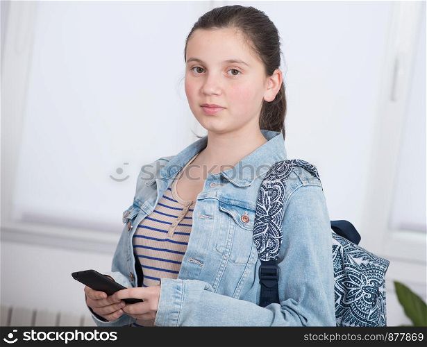 a portrait of schoolgirl using a phone