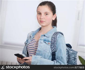 a portrait of schoolgirl using a phone