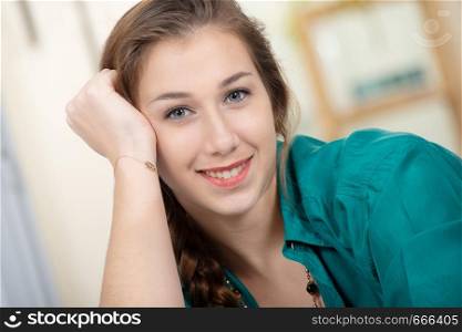 a portrait of smiling young woman dressed in green