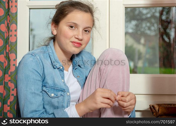 a portrait of teenage girl near the window