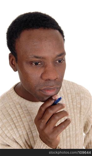 A portrait of the face of an African American handsome man with a penin his hand, thinking hard, isolated for white background