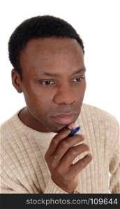 A portrait of the face of an African American handsome man with a penin his hand, thinking hard, isolated for white background