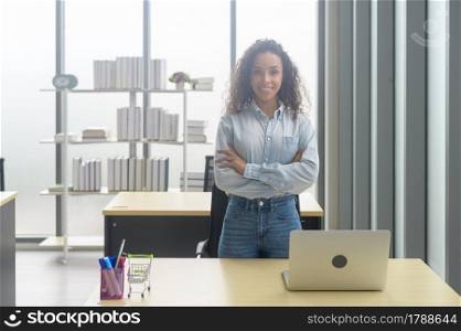 A portrait of young african businesswoman smiling in modern office. Portrait of young african businesswoman smiling in modern office