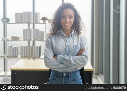 A portrait of young african businesswoman smiling in modern office. Portrait of young african businesswoman smiling in modern office