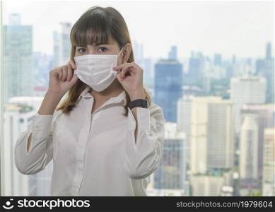 A Portrait of young beautiful Business Woman wearing a protective mask in modern office. Portrait of young beautiful Business Woman wearing a protective mask in modern office